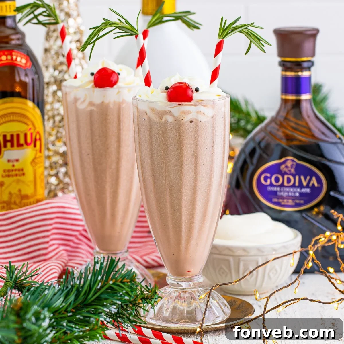 Drunk Rudolph Milkshakes on table with alcohol bottles behind glasses, creating a festive holiday scene.