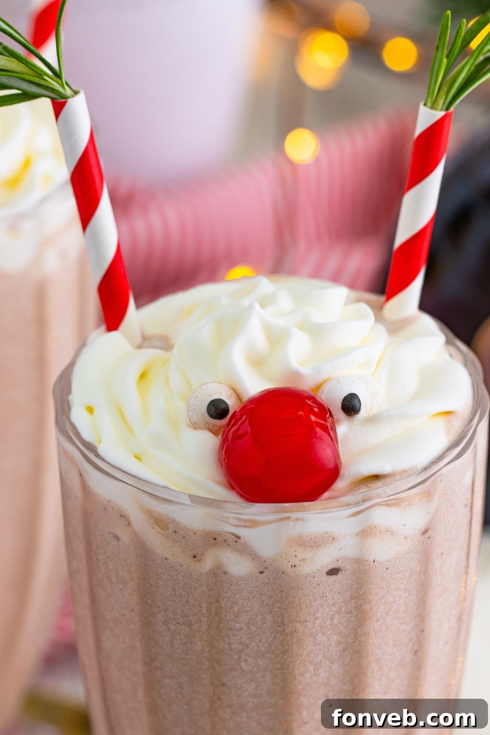 A beautifully decorated Drunk Rudolph Milkshake, complete with candy eyes, cherry nose, and rosemary antlers, ready to be served.