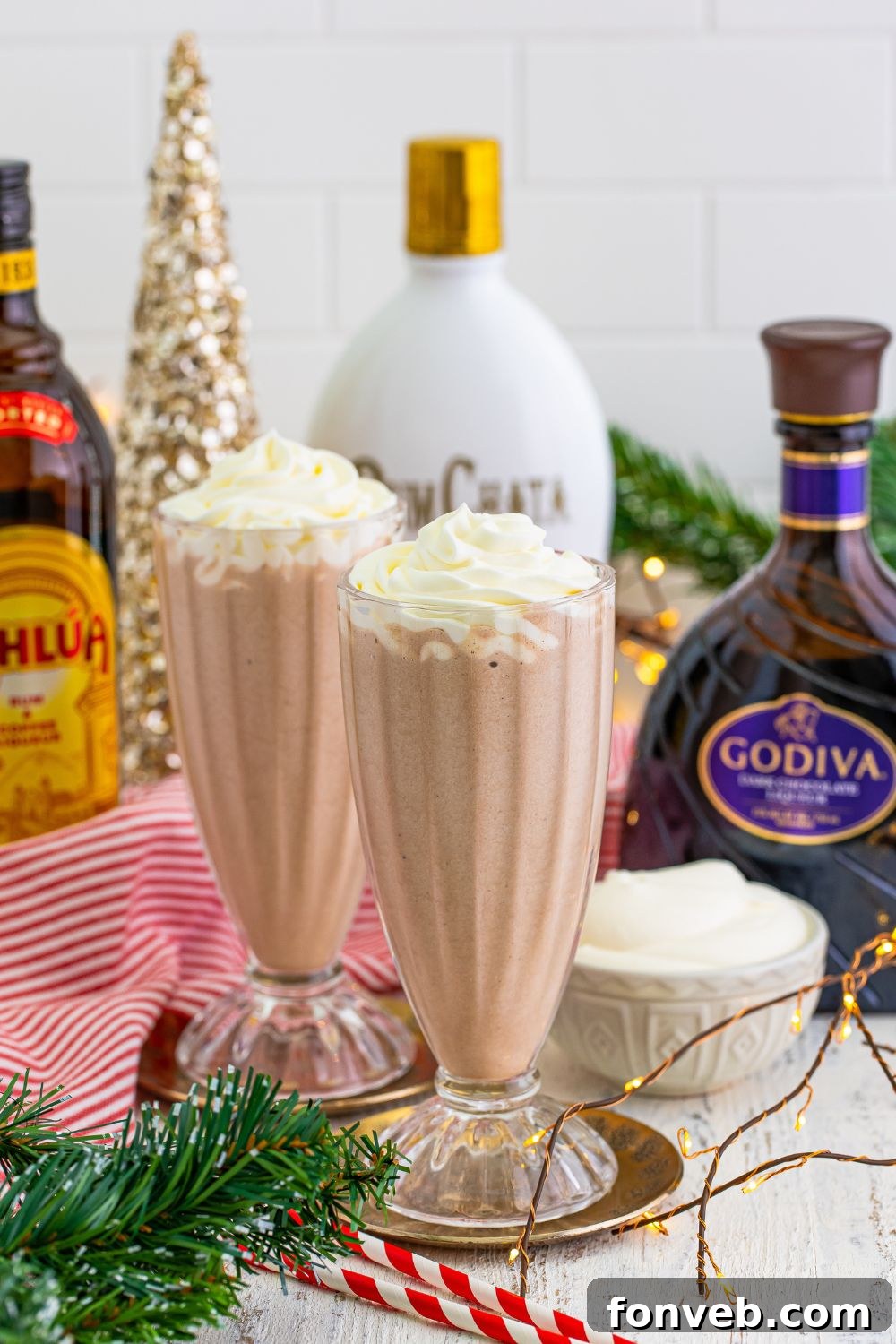 Drunk Rudolph Milkshakes in glasses, topped with generous whipped cream, ready for festive enjoyment.