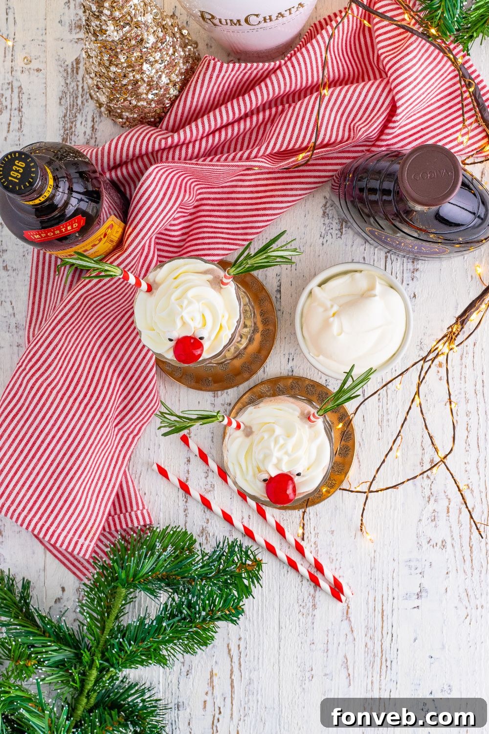 Overhead view of Drunk Rudolph Milkshakes in glasses, surrounded by festive Christmas decor on a tabletop.
