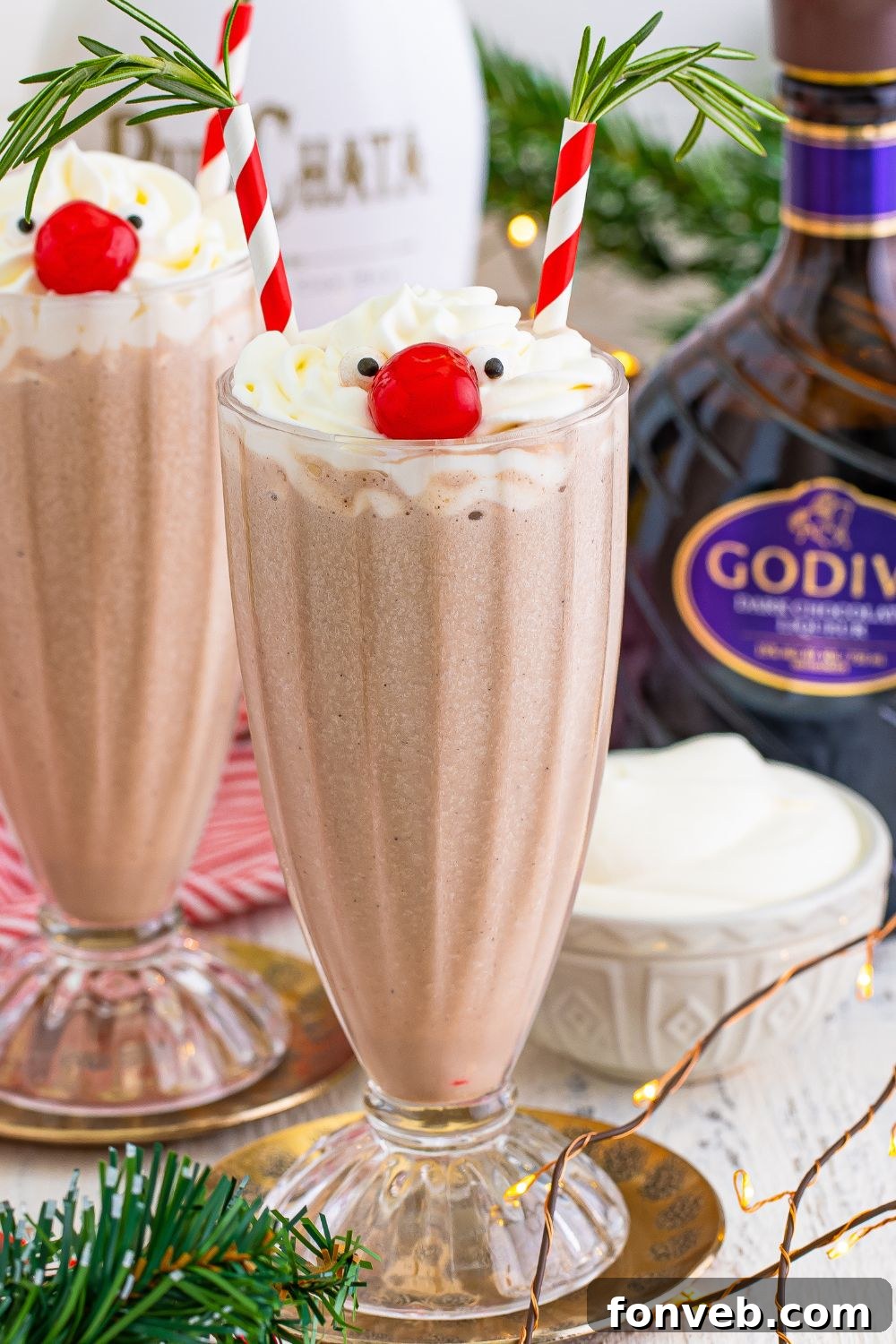A trio of Drunk Reindeer Milkshakes, beautifully decorated, resting on a festive table.