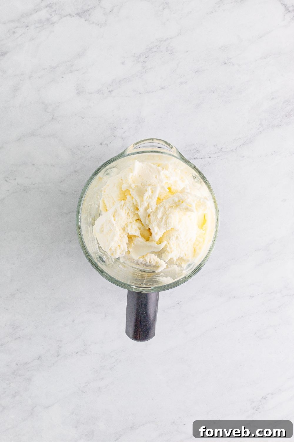 A blender with vanilla ice cream, ready for making the Drunk Rudolph Milkshake.