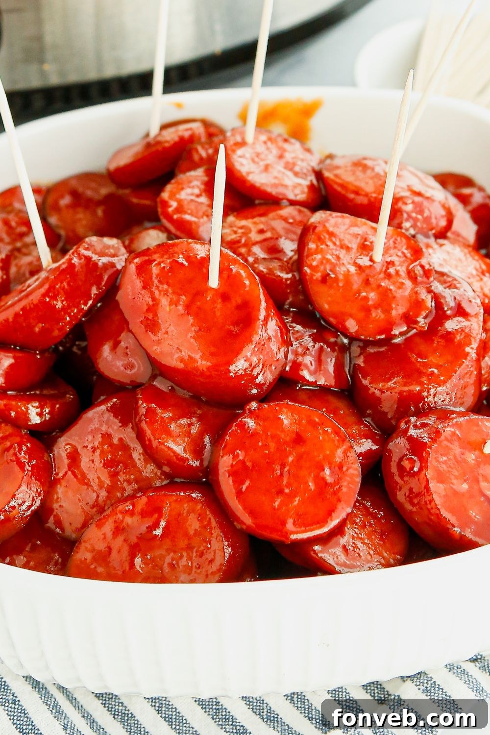 Bowl of Crockpot Kielbasa Bites with toothpicks for easy serving, a perfect party snack.