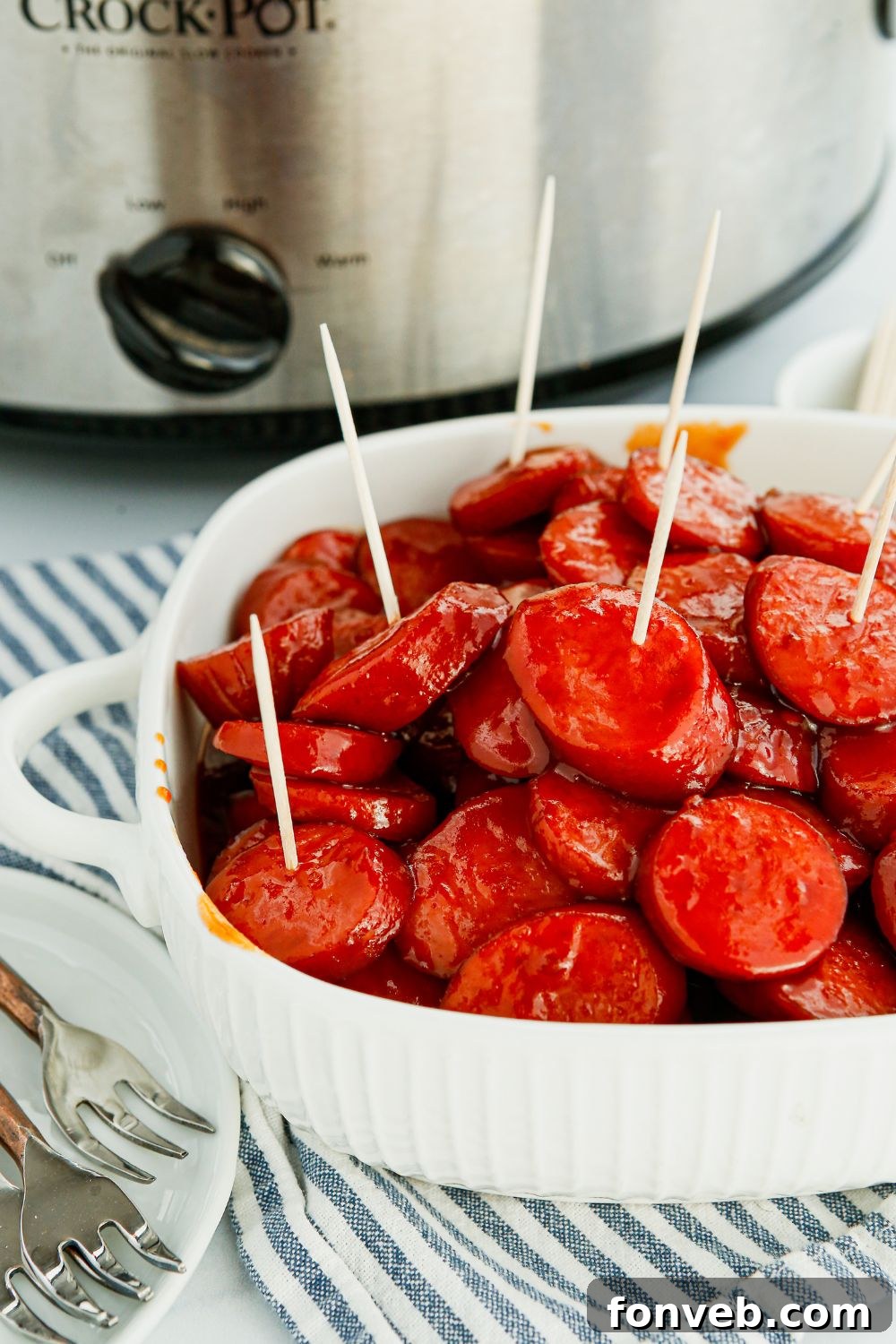 Crockpot Kielbasa Bites in a rustic bowl with toothpicks, perfect for sharing.