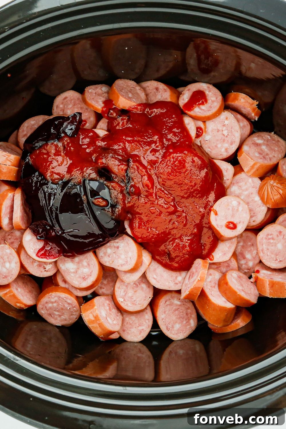 Kielbasa ingredients, with sliced sausage and the sweet and spicy sauce poured over it.