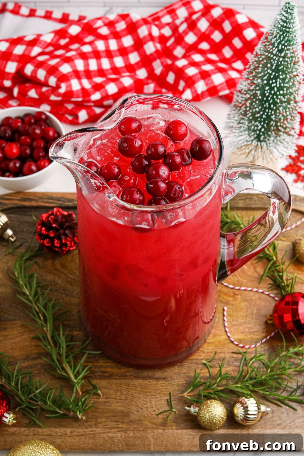 Yuletide Kiss Punch 15 Mistletoe Punch in a pitcher on table with Christmas decora around it