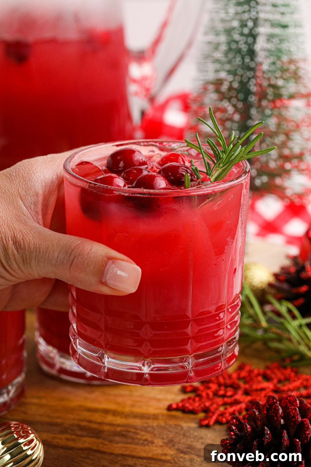 Yuletide Kiss Punch 4 christmas cocktail punch in hand in a glass