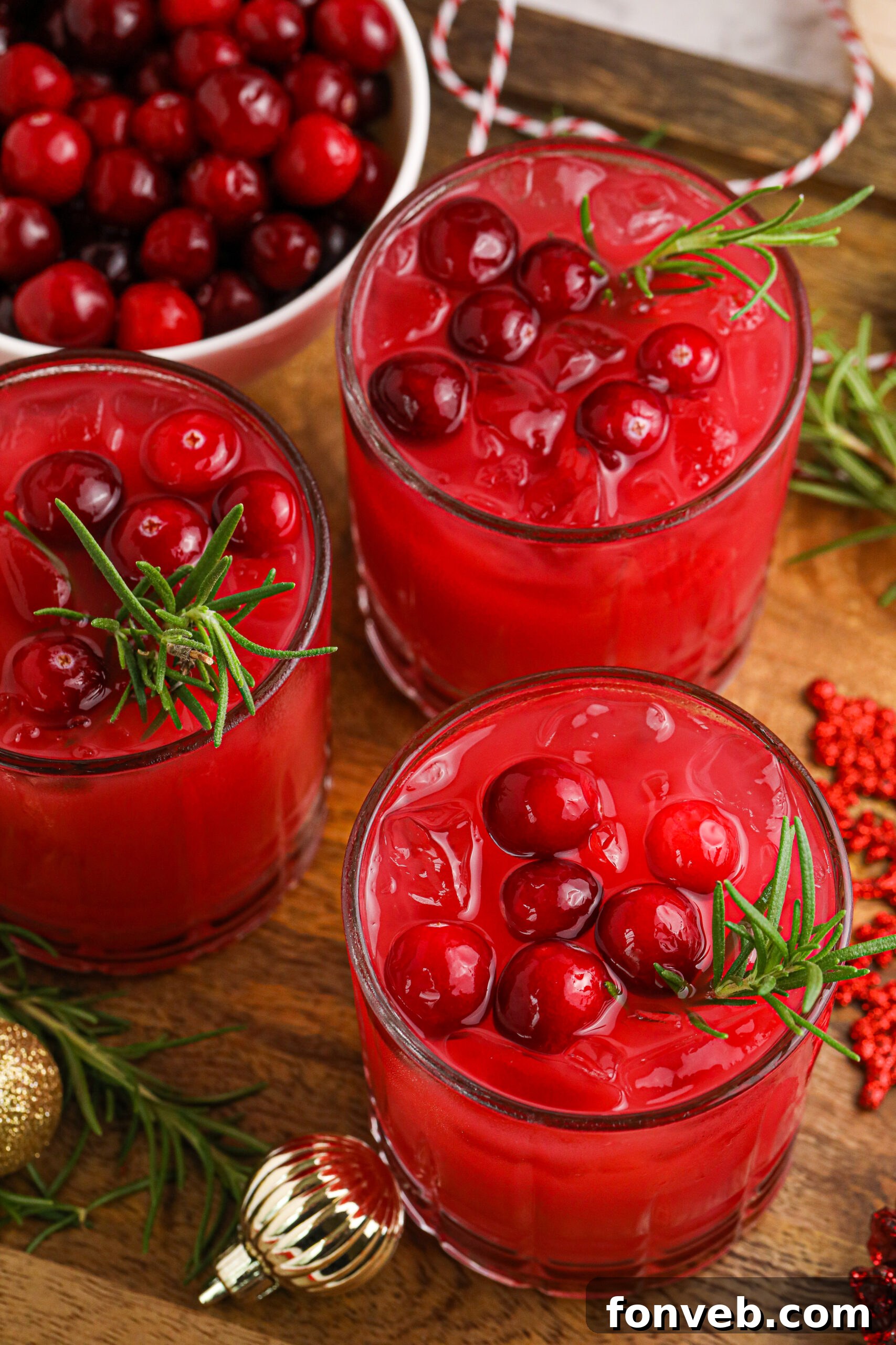 Yuletide Kiss Punch 10 three glasses of cranberry punch on a wooden board