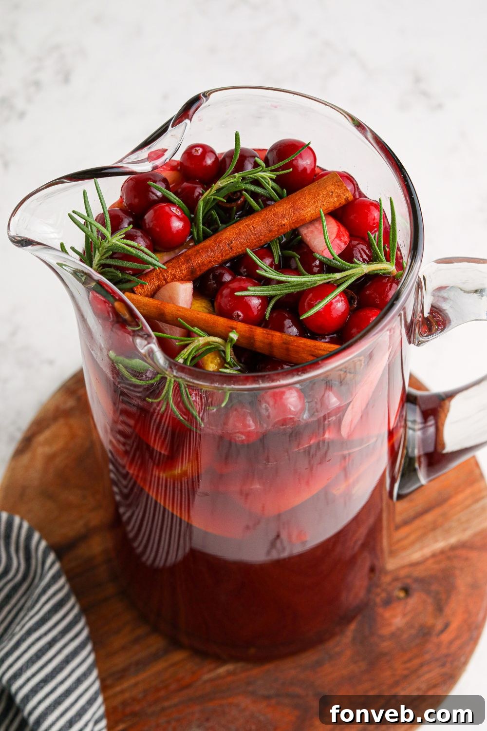Overhead shot of glasses filled with festive sangria, garnished with fruit.