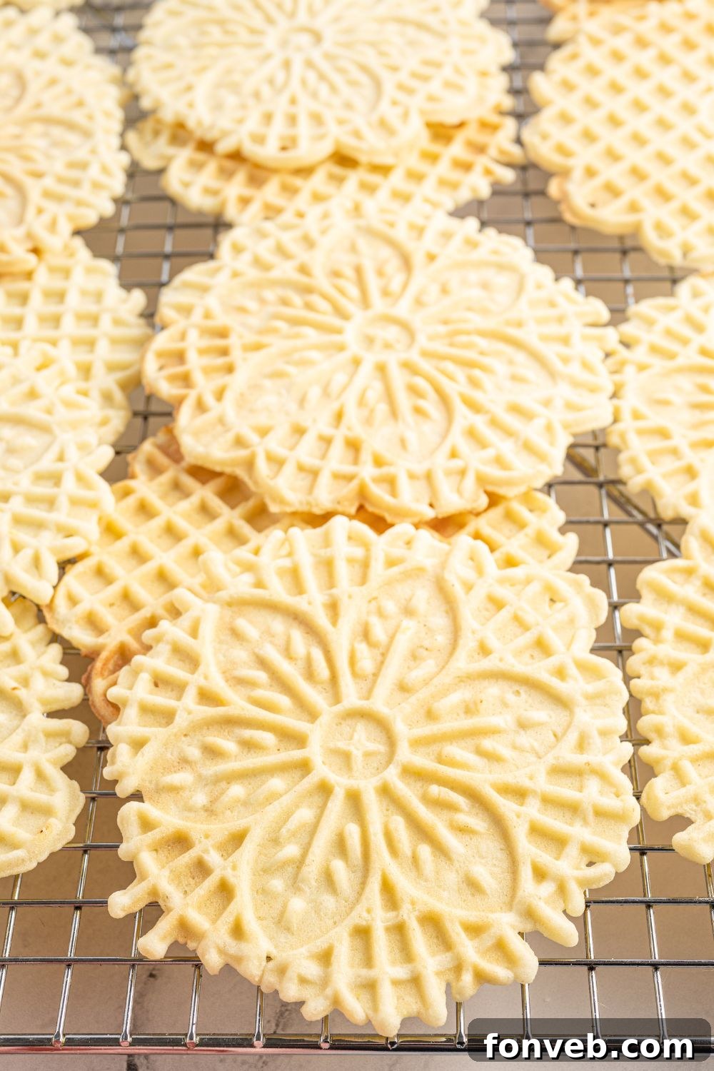 Pizzelles on cooling tray stacked on top of each other 