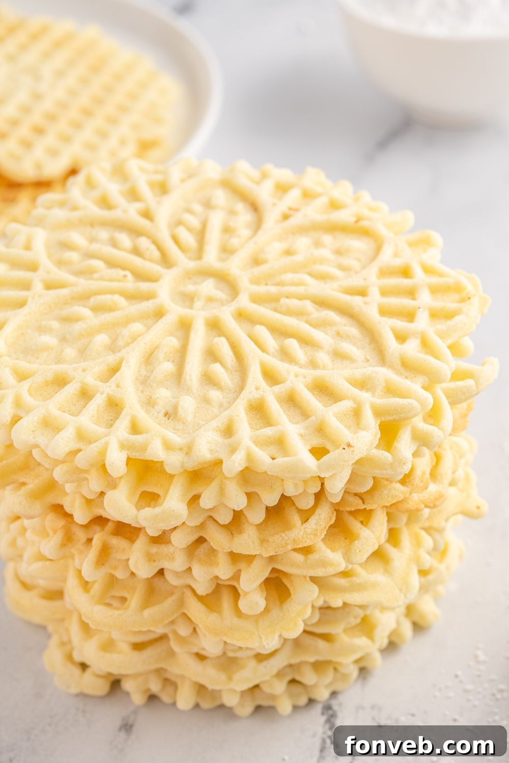 Pizzelles stacked on table