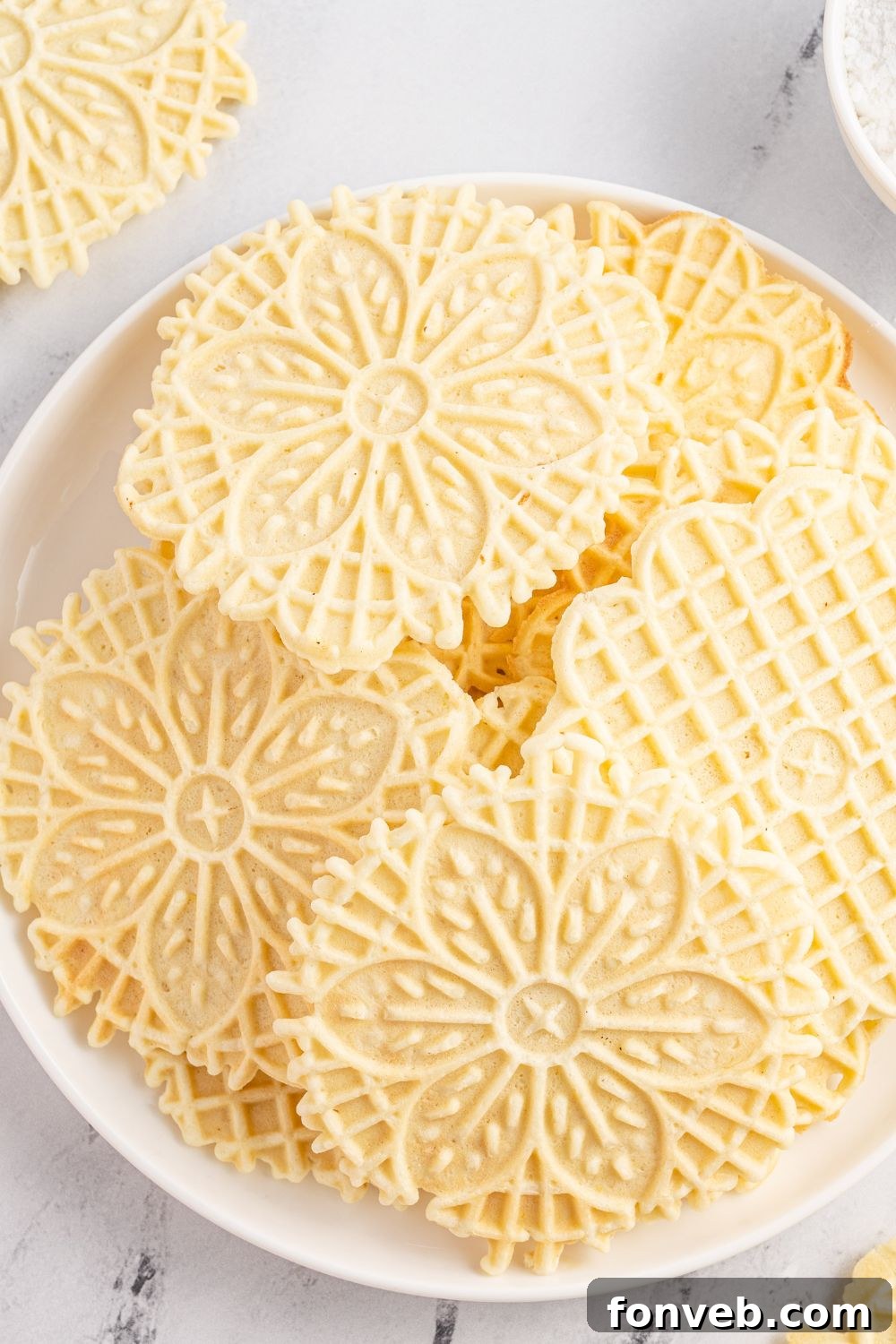 Pizzelles stacked on plate 
