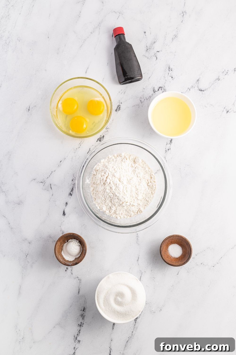 ingredients to make Pizzelles cookies on a marble counter 
