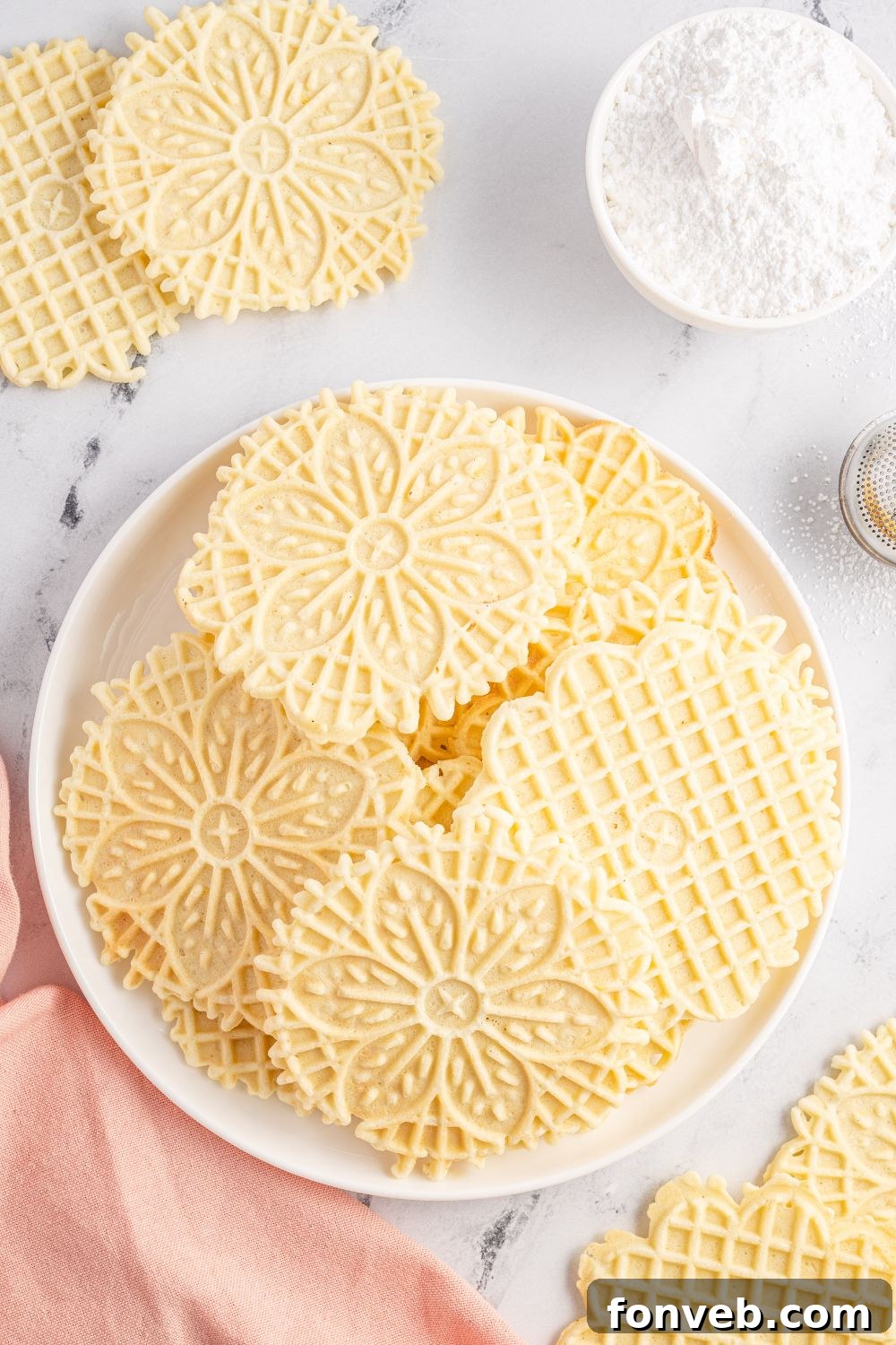 plate with pizzelle cookies on it