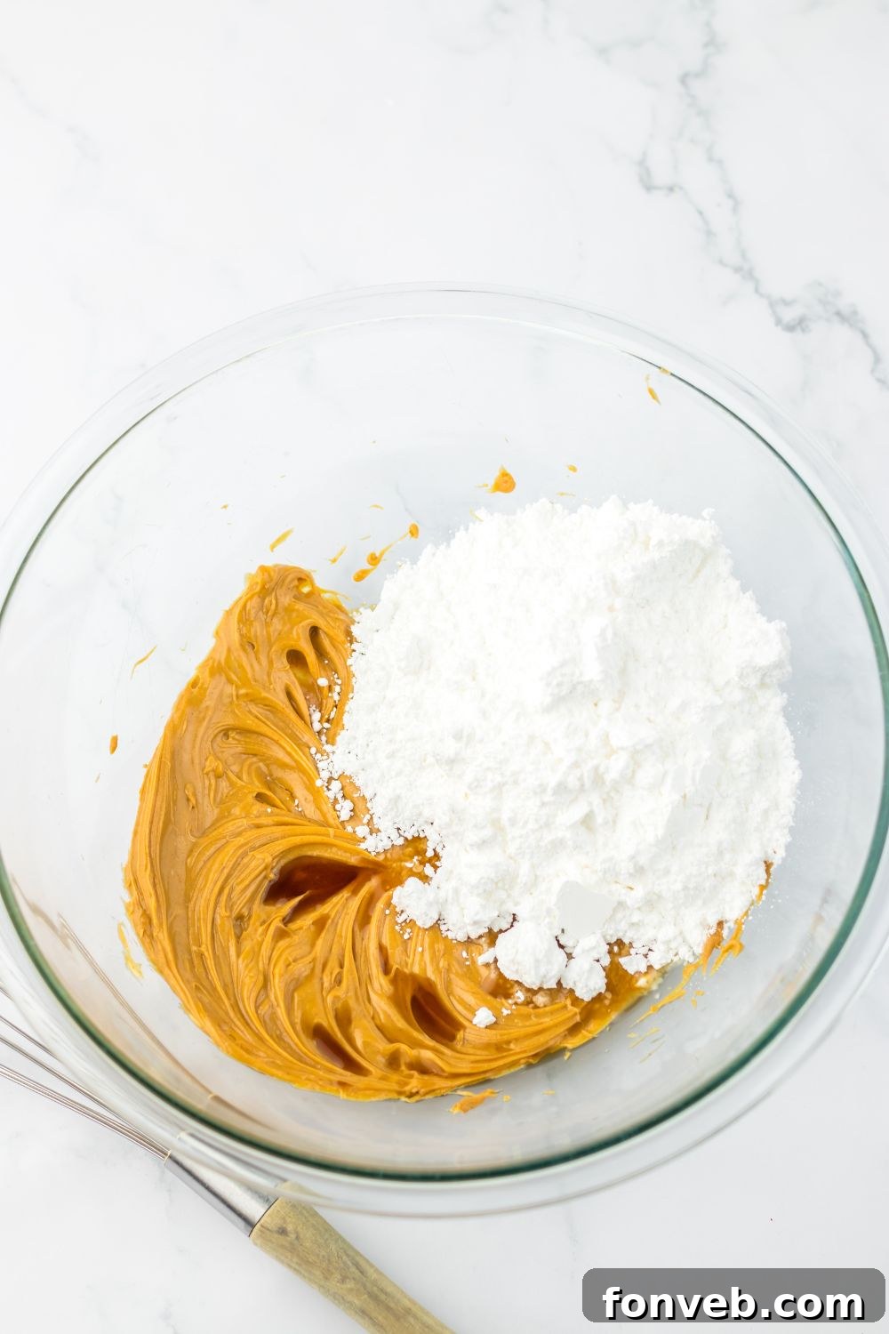 peanut butter and powdered sugar mixed up in a bowl