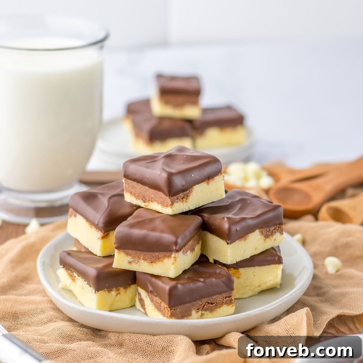 Boston Cream Dream Fudge 2 Boston Cream Pie Fudge stacked on table with glass of milk behind it