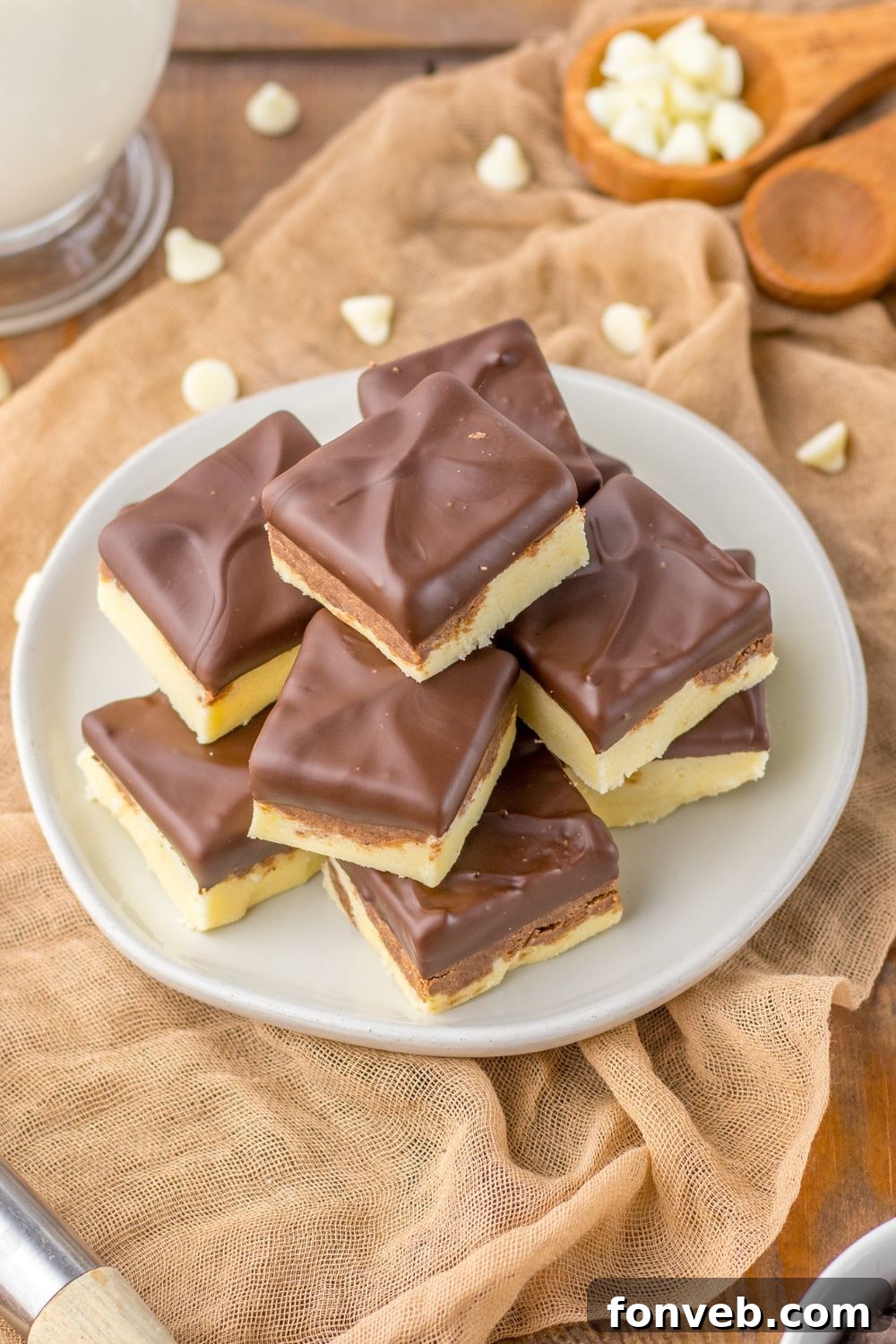 Boston Cream Dream Fudge 13 side view of fudge on table with white chocolate chips around it