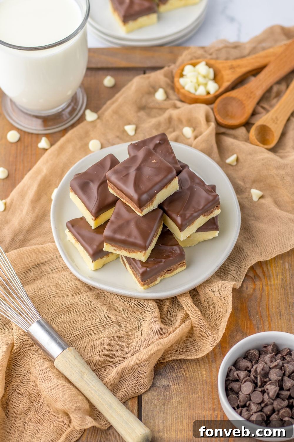 Boston Cream Dream Fudge 3 fudge on table with chocolate chips and items around it