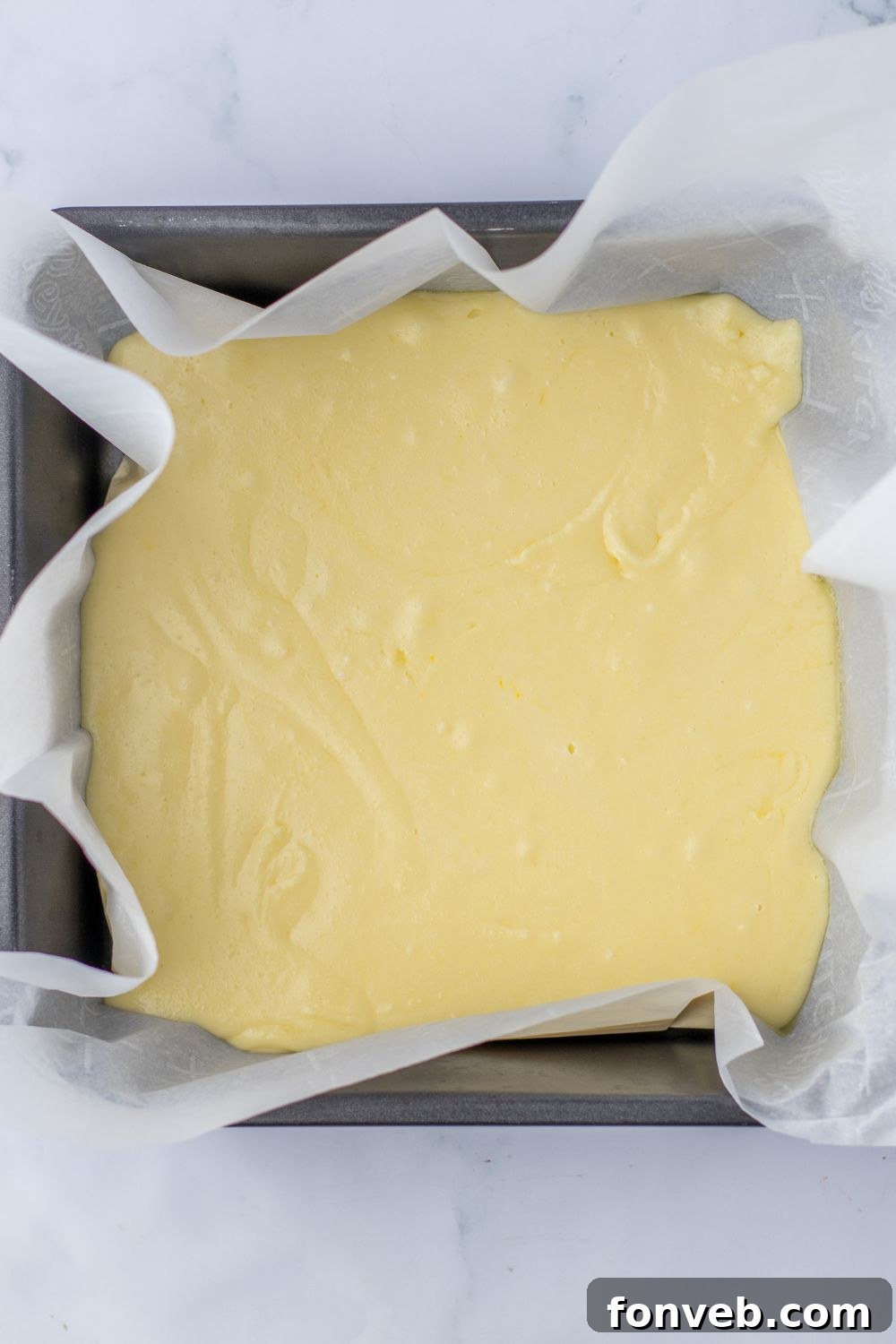 Boston Cream Dream Fudge 6 vanilla fudge in a pan with parchment paper