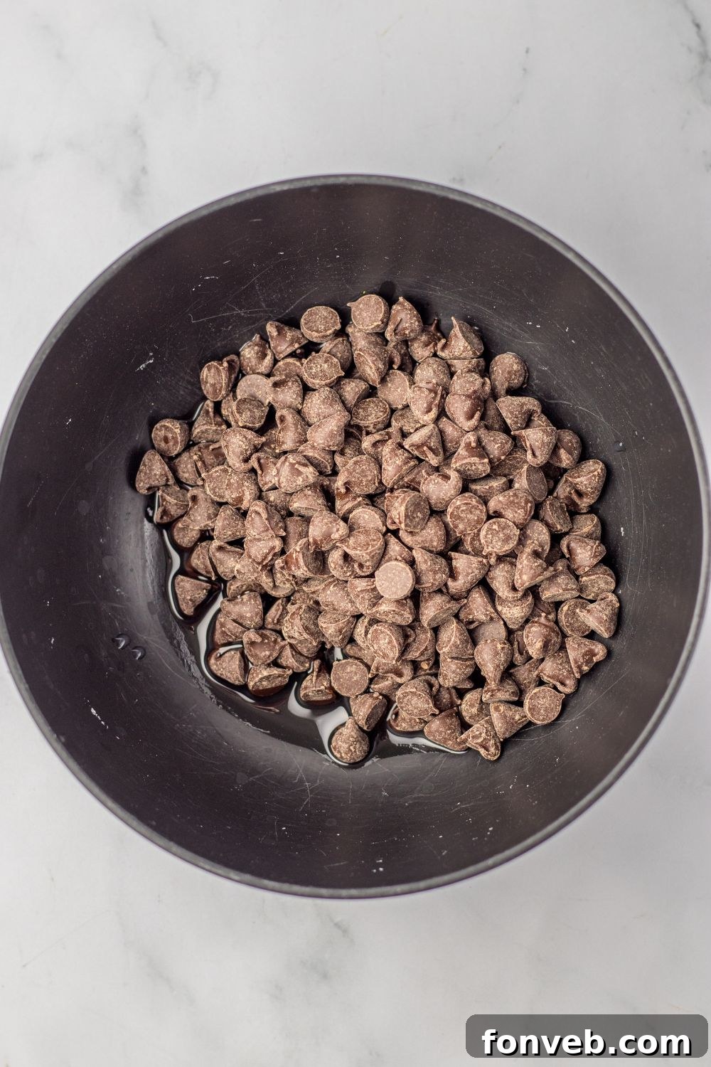 Boston Cream Dream Fudge 8 chocolate chips with oil in a bowl