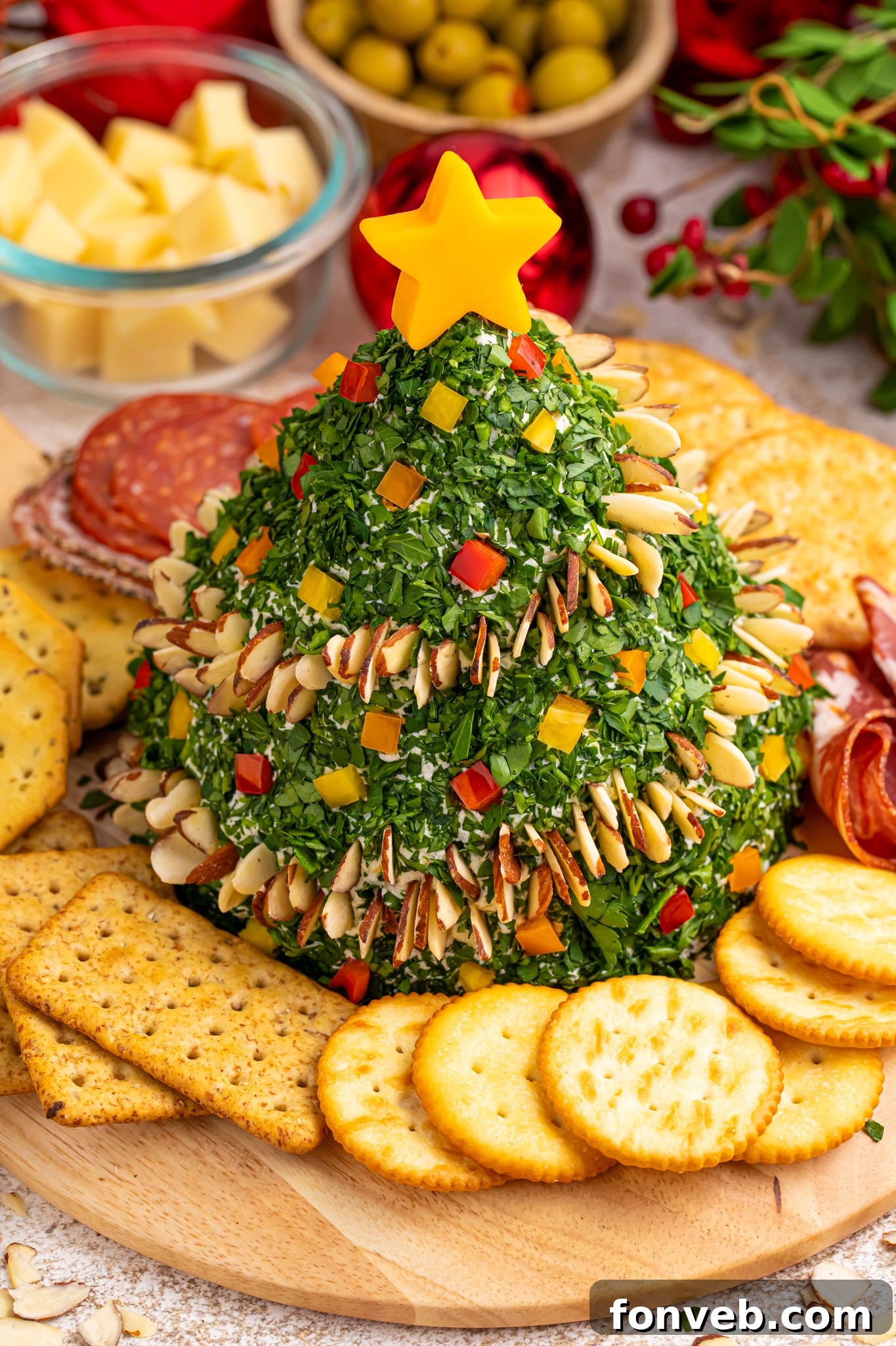 Christmas Tree Cheeseball on a platter, garnished with festive decorations