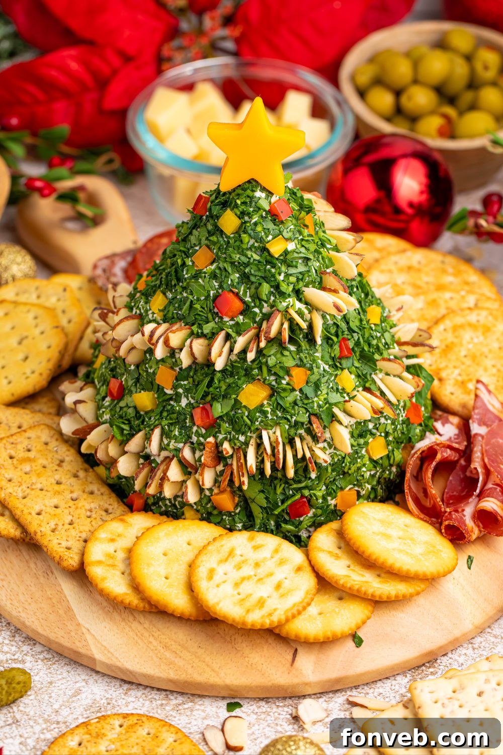 Appetizer platter featuring the cheeseball with a variety of crackers and crudités