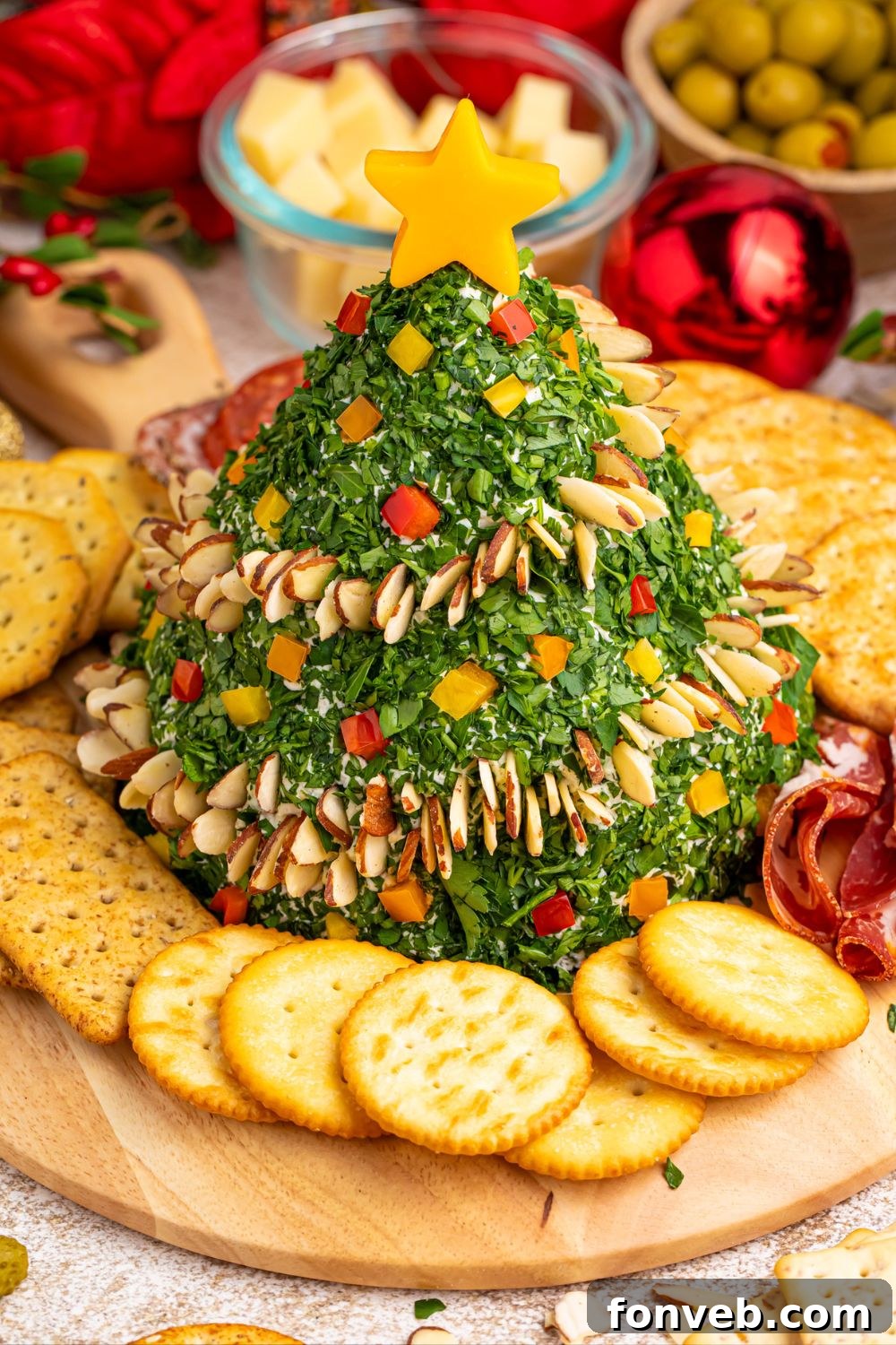 Christmas Tree Cheeseball beautifully showcased on a festive table setting