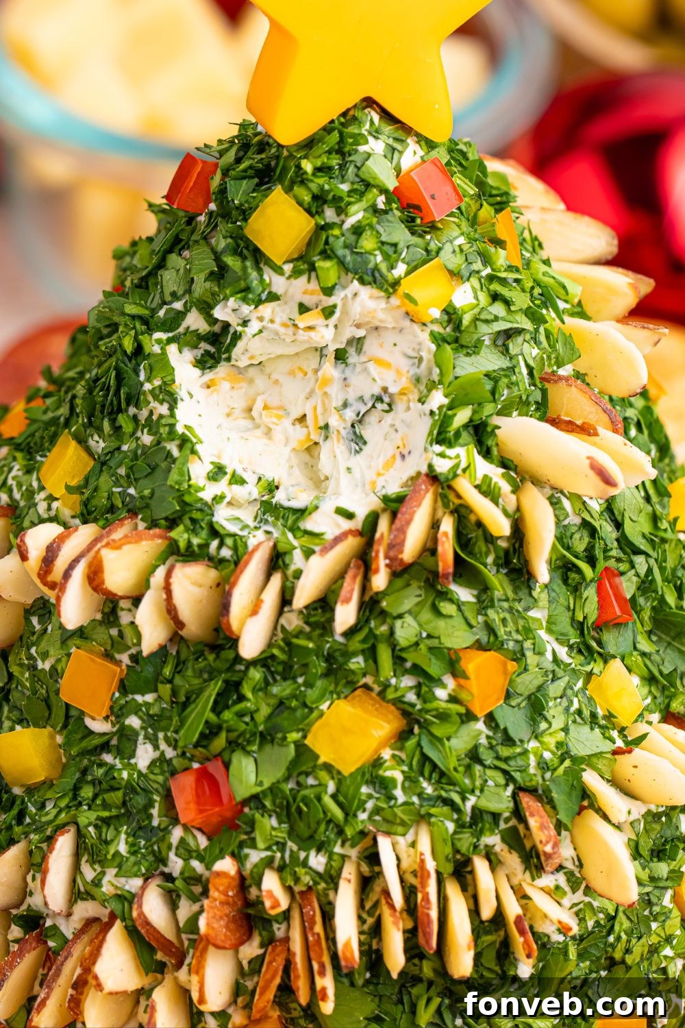 Cheeseball on a platter with some removed, indicating its deliciousness