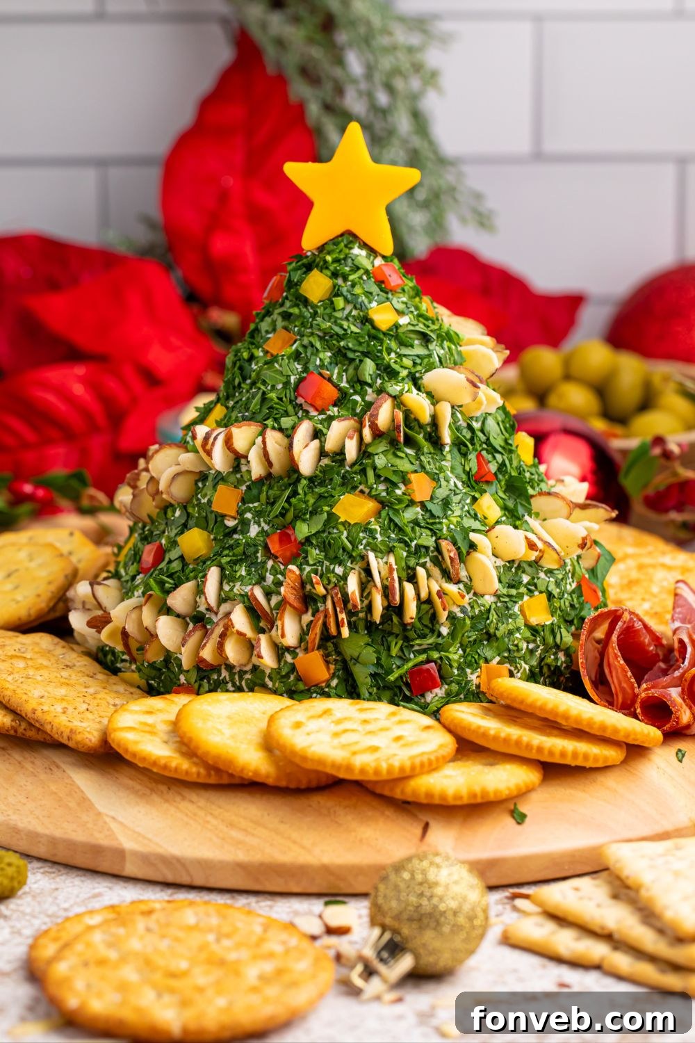 Christmas Tree Cheeseball on a table, surrounded by its fresh ingredients
