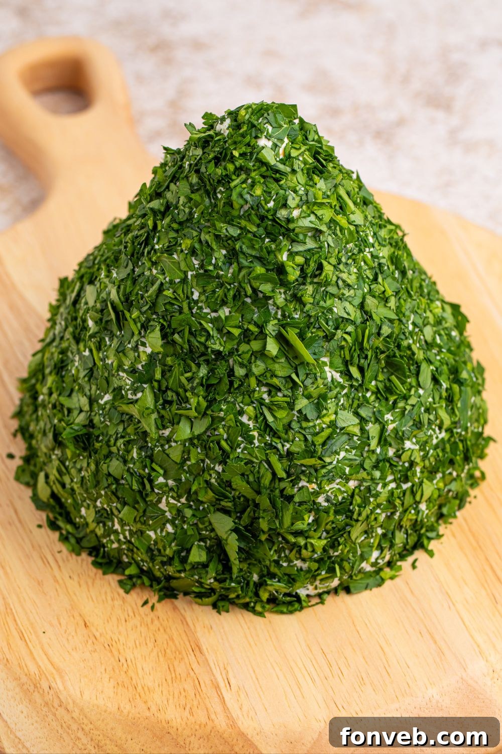 Cheeseball generously coated in fresh, finely chopped parsley, resembling a tree