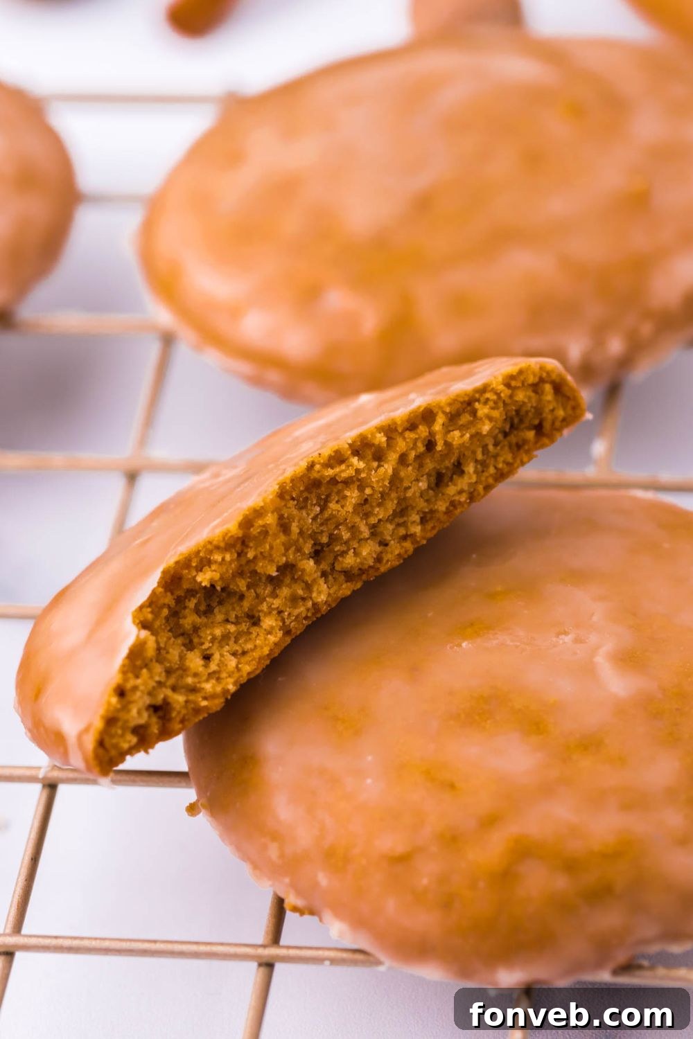 A single cookie cut cleanly in half, placed on a cooling rack to highlight its texture.