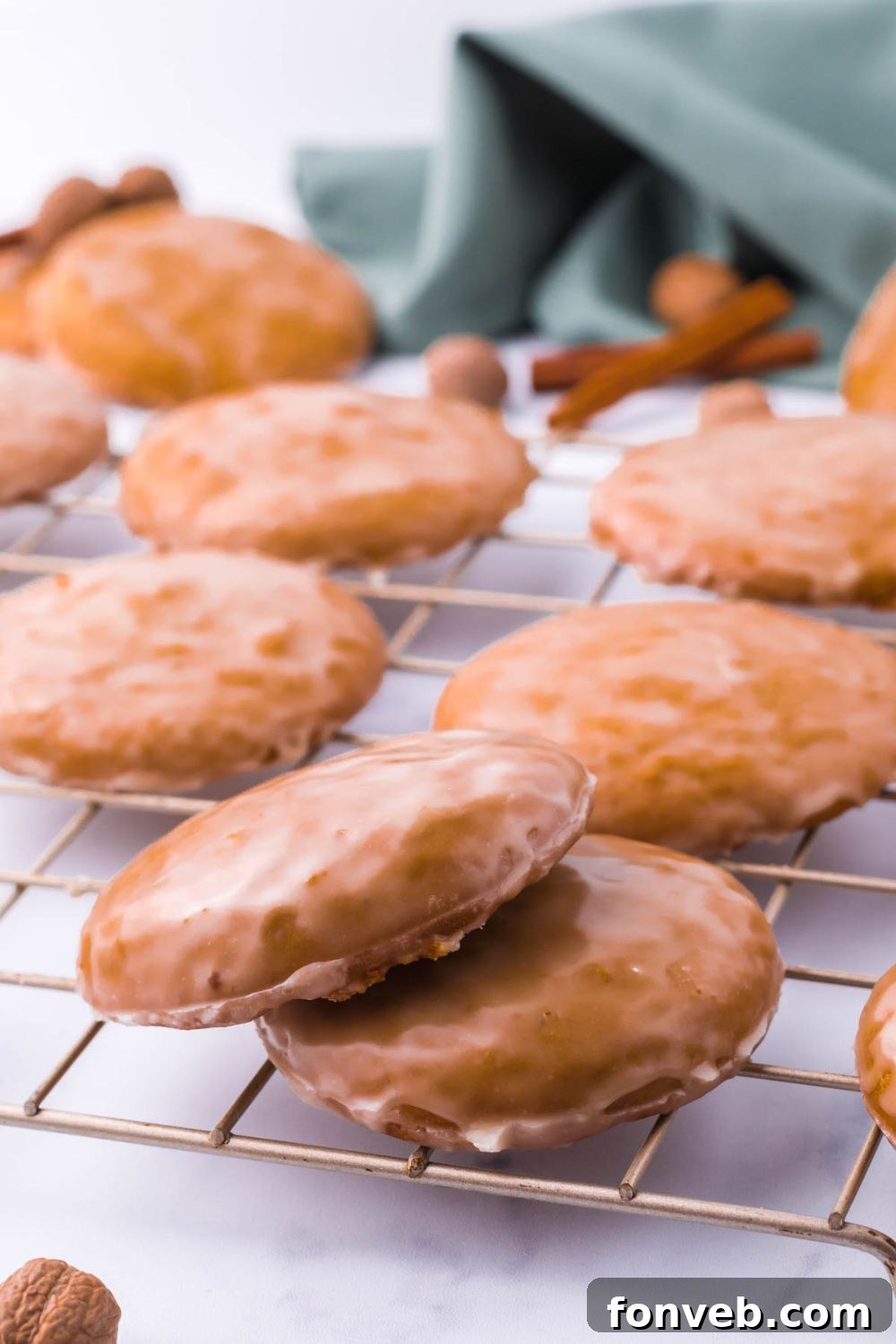 A neat stack of baked cookies resting on a table, showcasing their golden-brown hue.