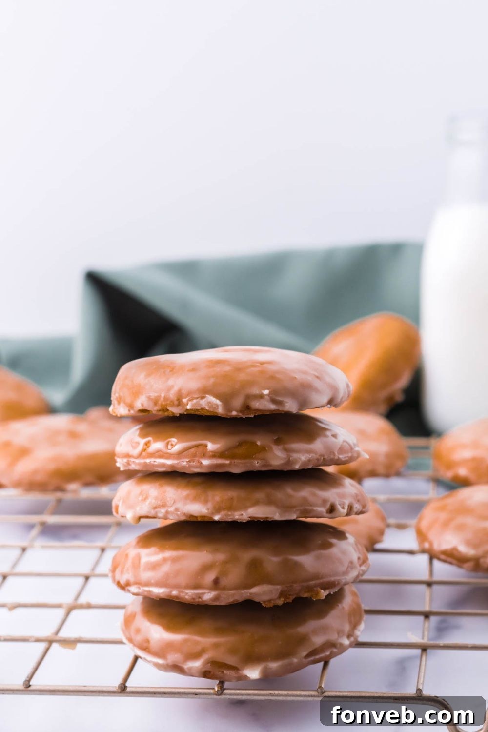 A visually appealing stack of cookies on a cooling rack, perfectly arranged one on top of the other.