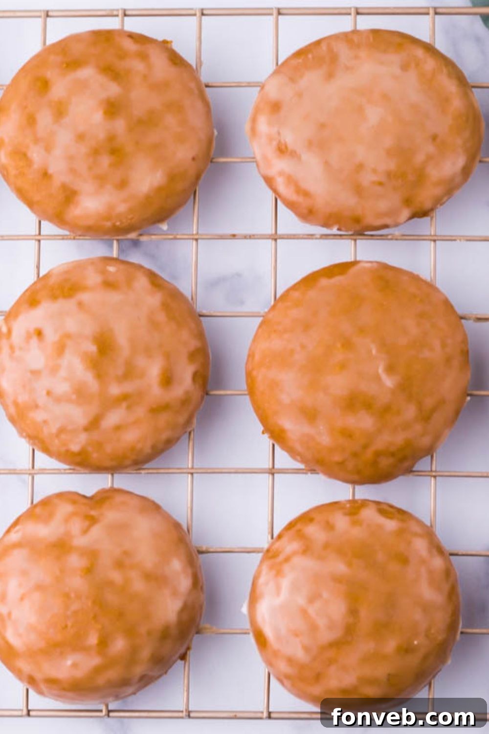 Warm German cookies artfully arranged on a metal cooling rack set upon a kitchen table, ready to be enjoyed.