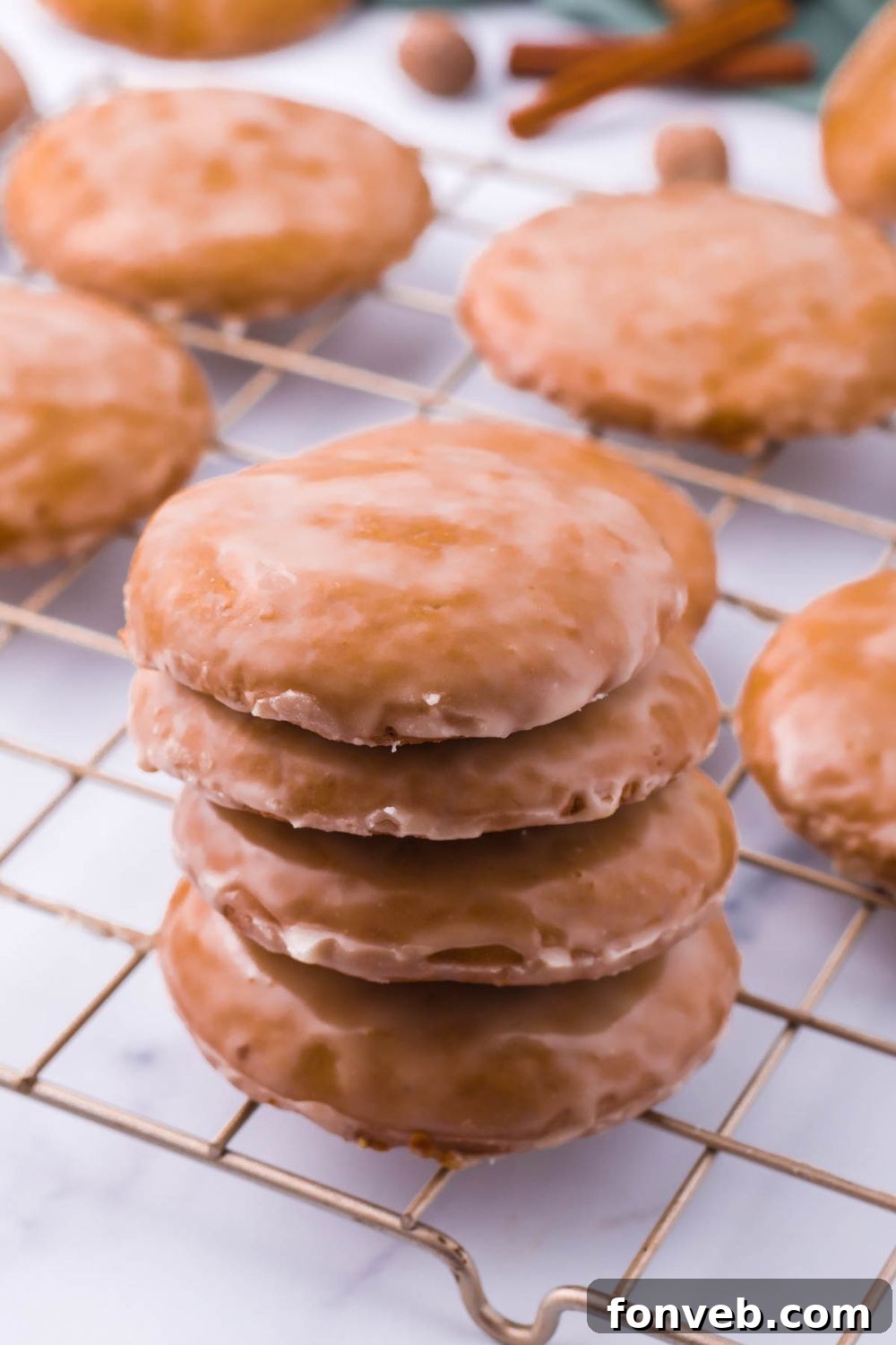 A tidy stack of baked cookies, arranged on a cooling rack.