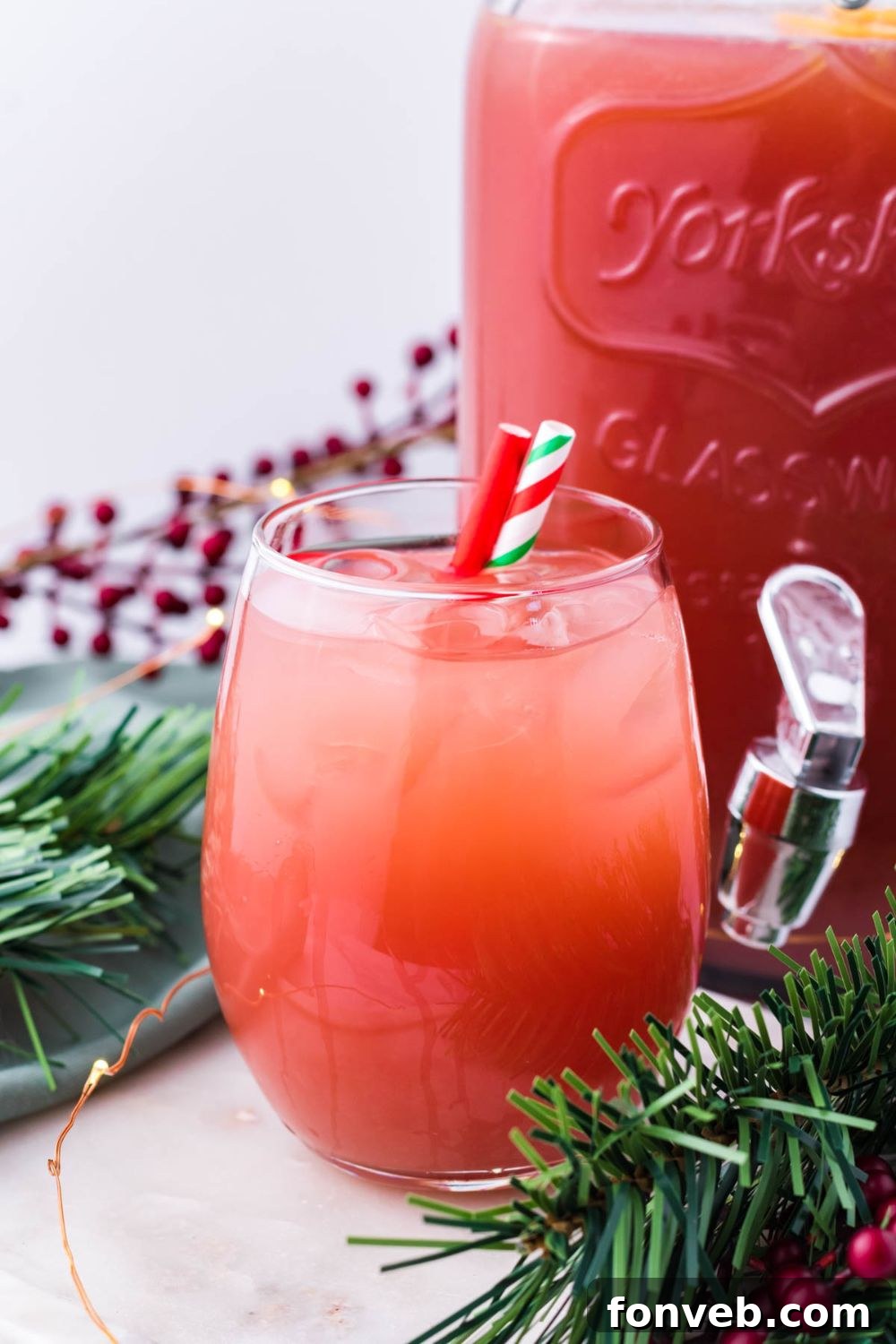 Mistletoe Mix 5 Holiday Punch in a pitcher and a glass on table