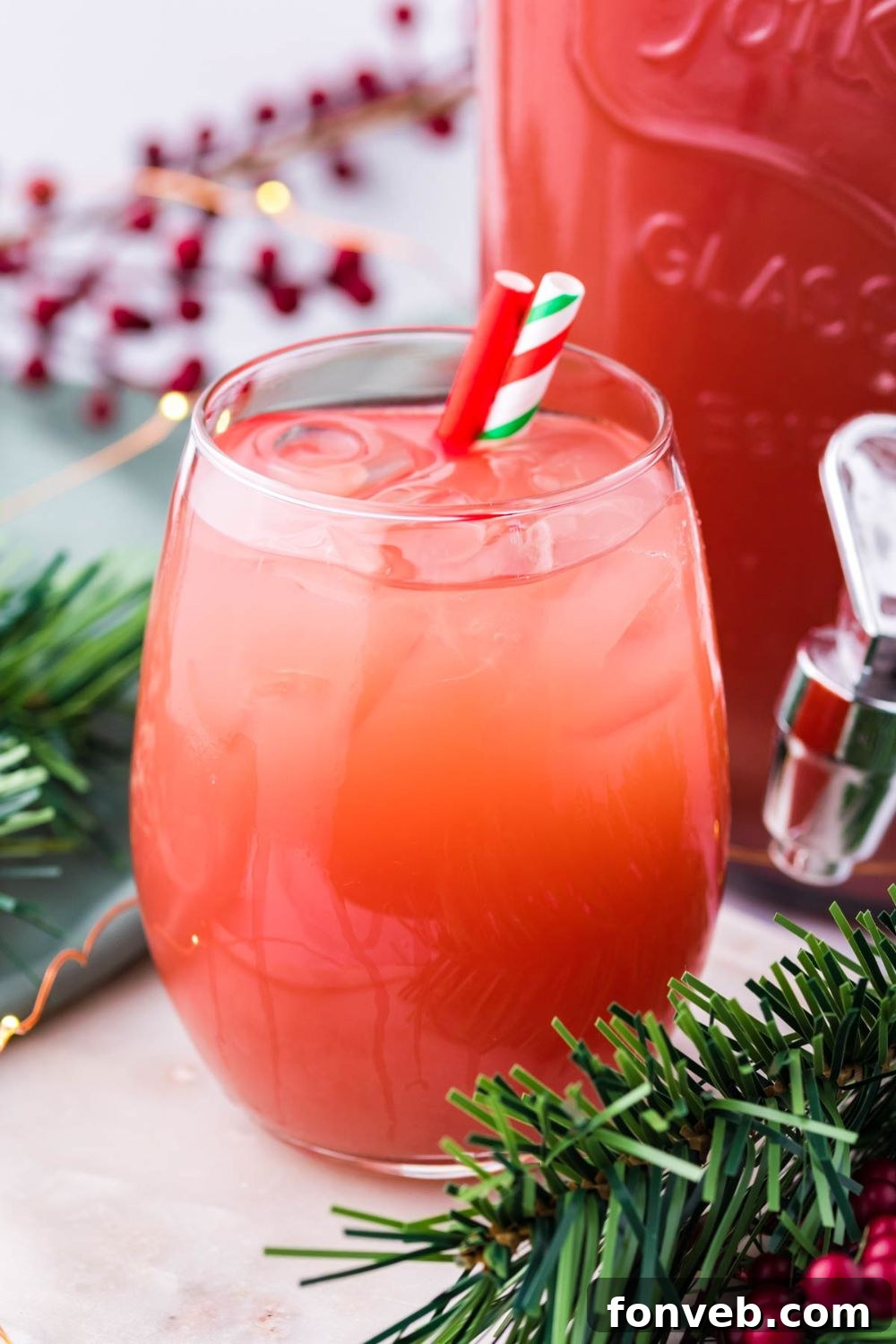 Mistletoe Mix 6 Holiday Punch in glass with straws on table