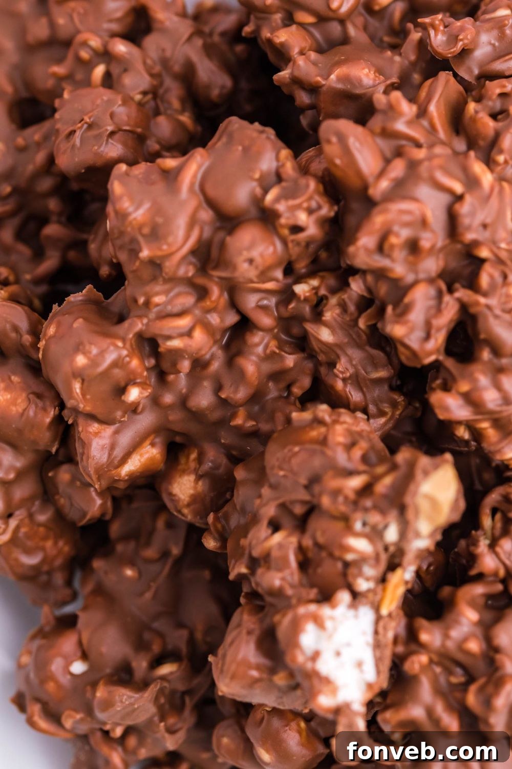 Close-up of Rocky Road Candy pieces stacked on a table, highlighting the different textures.