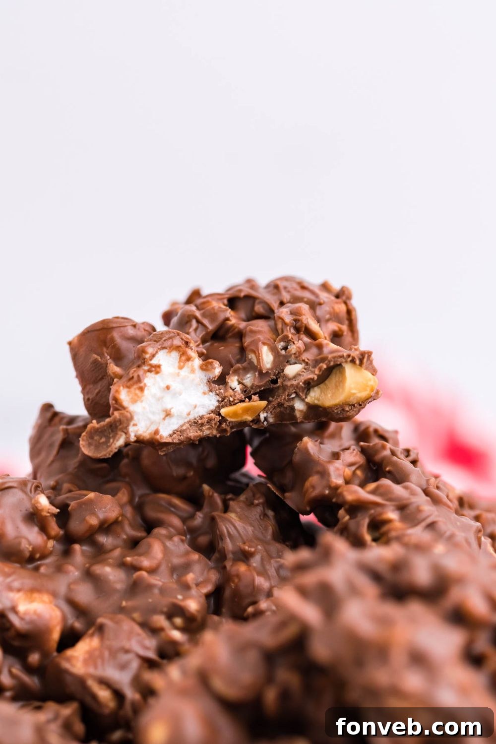 Several pieces of Rocky Road Candy stacked neatly on a table, ready to be enjoyed.