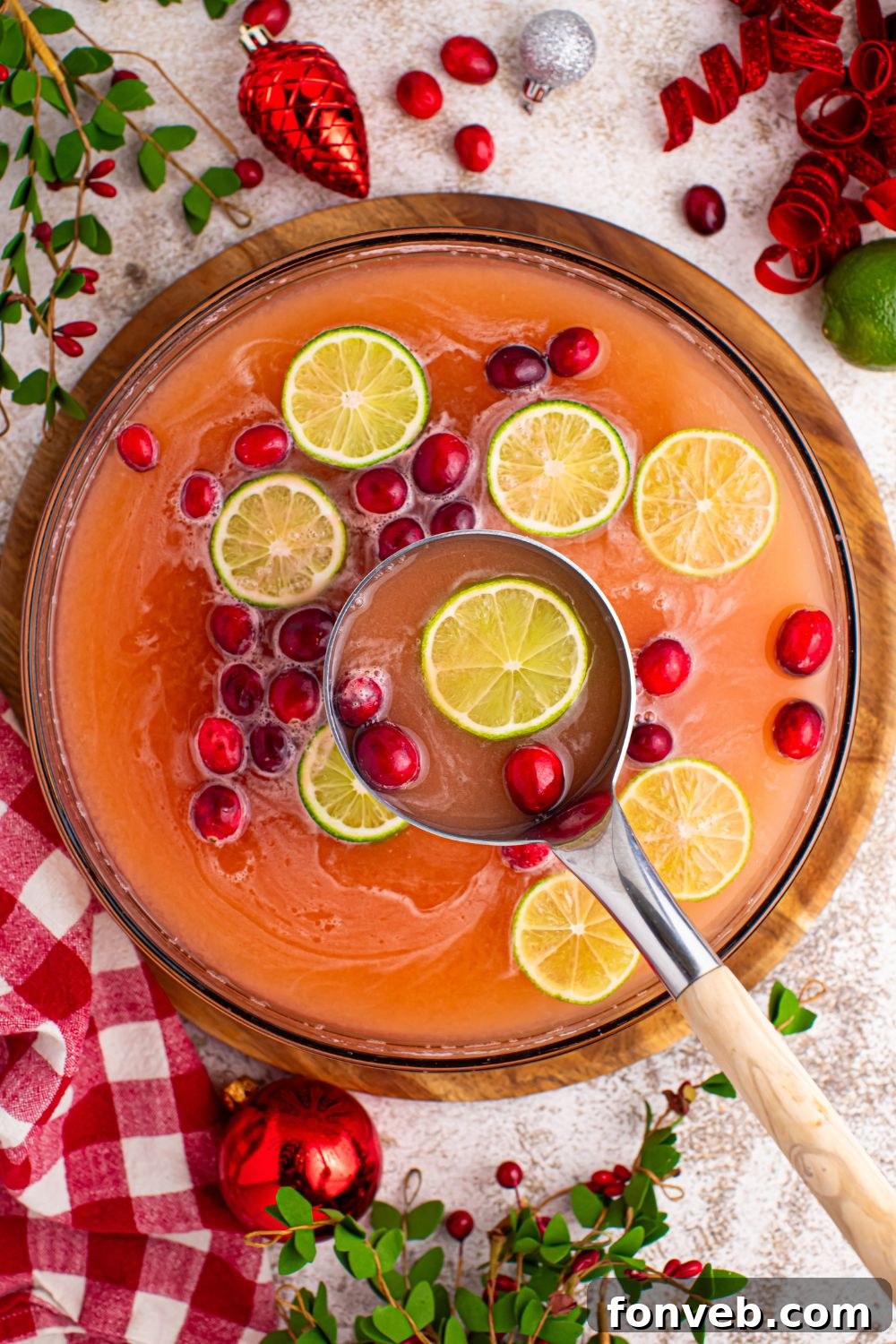 A ladle scooping a portion of the frothy Giggle Juice punch from a bowl, highlighting the texture and color.