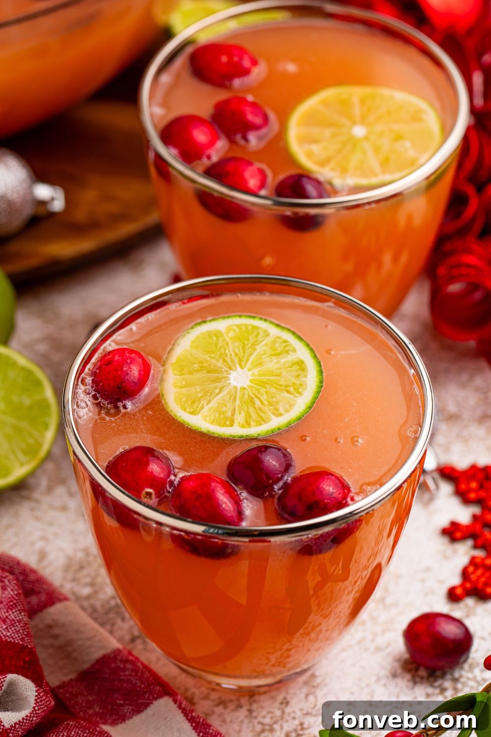 A single glass of frothy punch on a wooden table, featuring the inviting layers and texture of Giggle Juice.