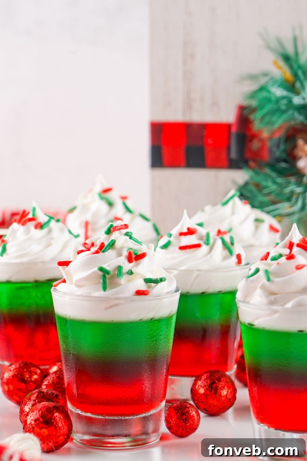 Yuletide Jiggle Shots 16 jello shots with Christmas decor around it on table