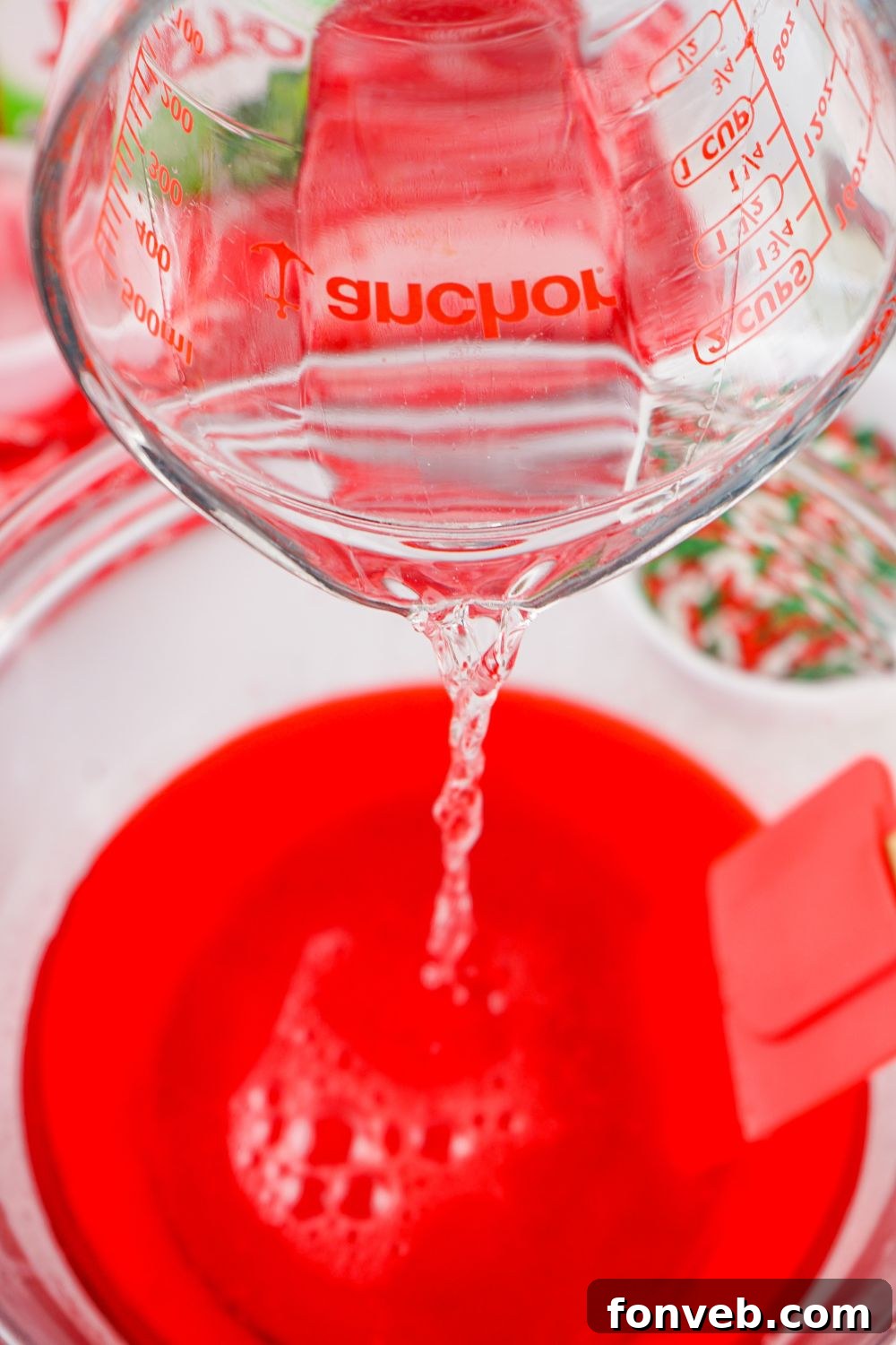 Yuletide Jiggle Shots 8 adding vodka in jello bowl
