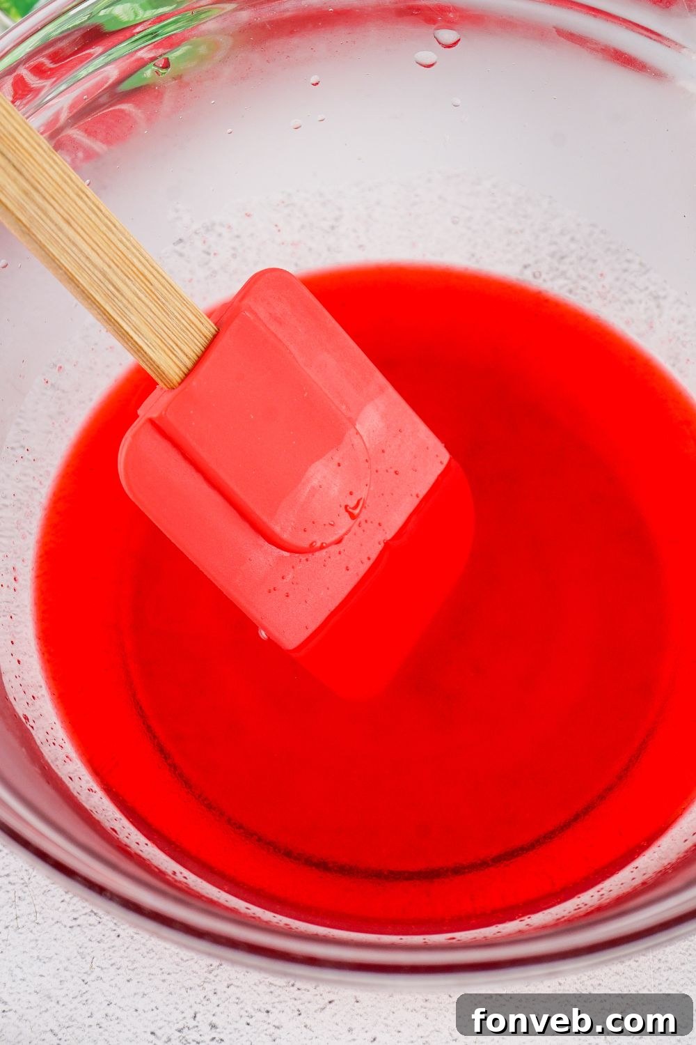 Yuletide Jiggle Shots 9 stirring with a rubber spatula