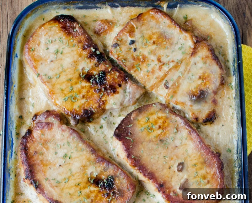 Close-up of golden brown smothered pork chop scalloped potato casserole, ready to serve.
