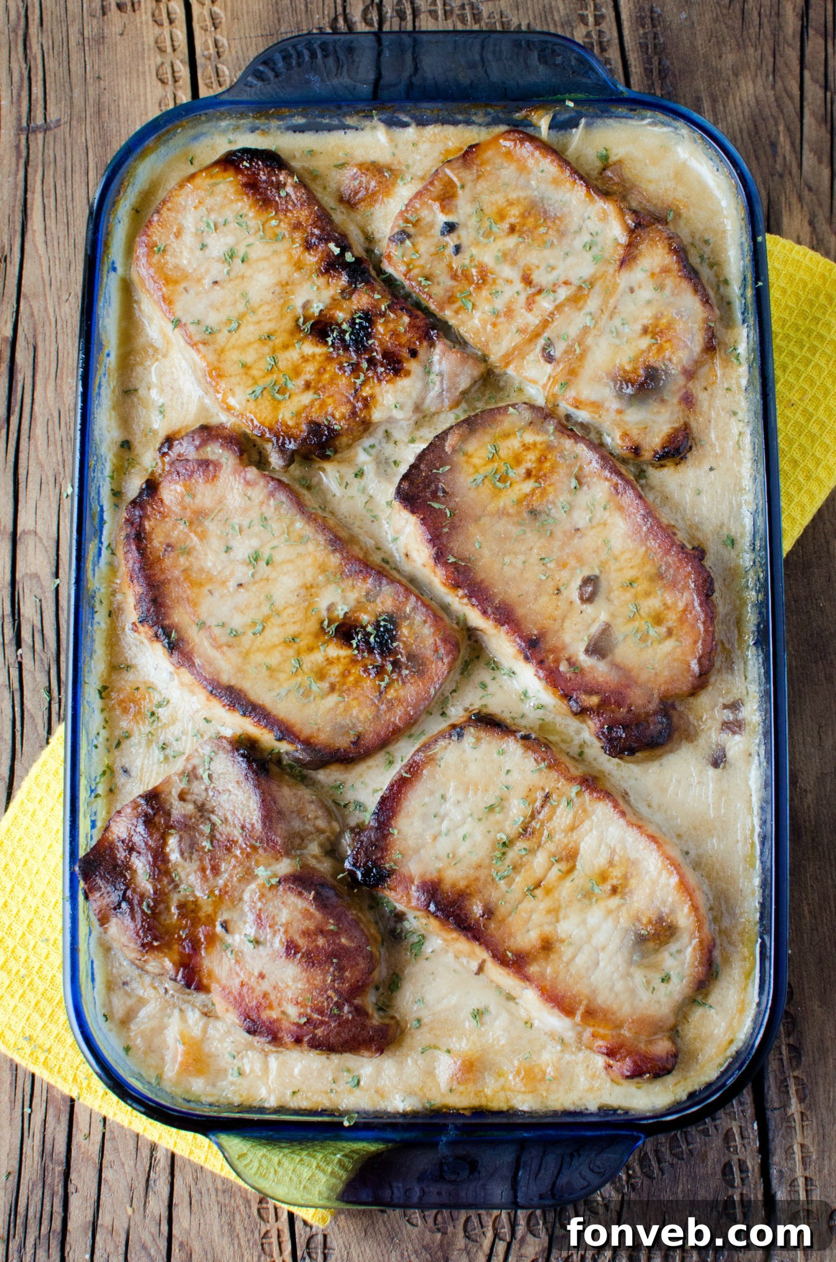 Another perspective of the freshly baked smothered pork chop and scalloped potato casserole, inviting and warm.