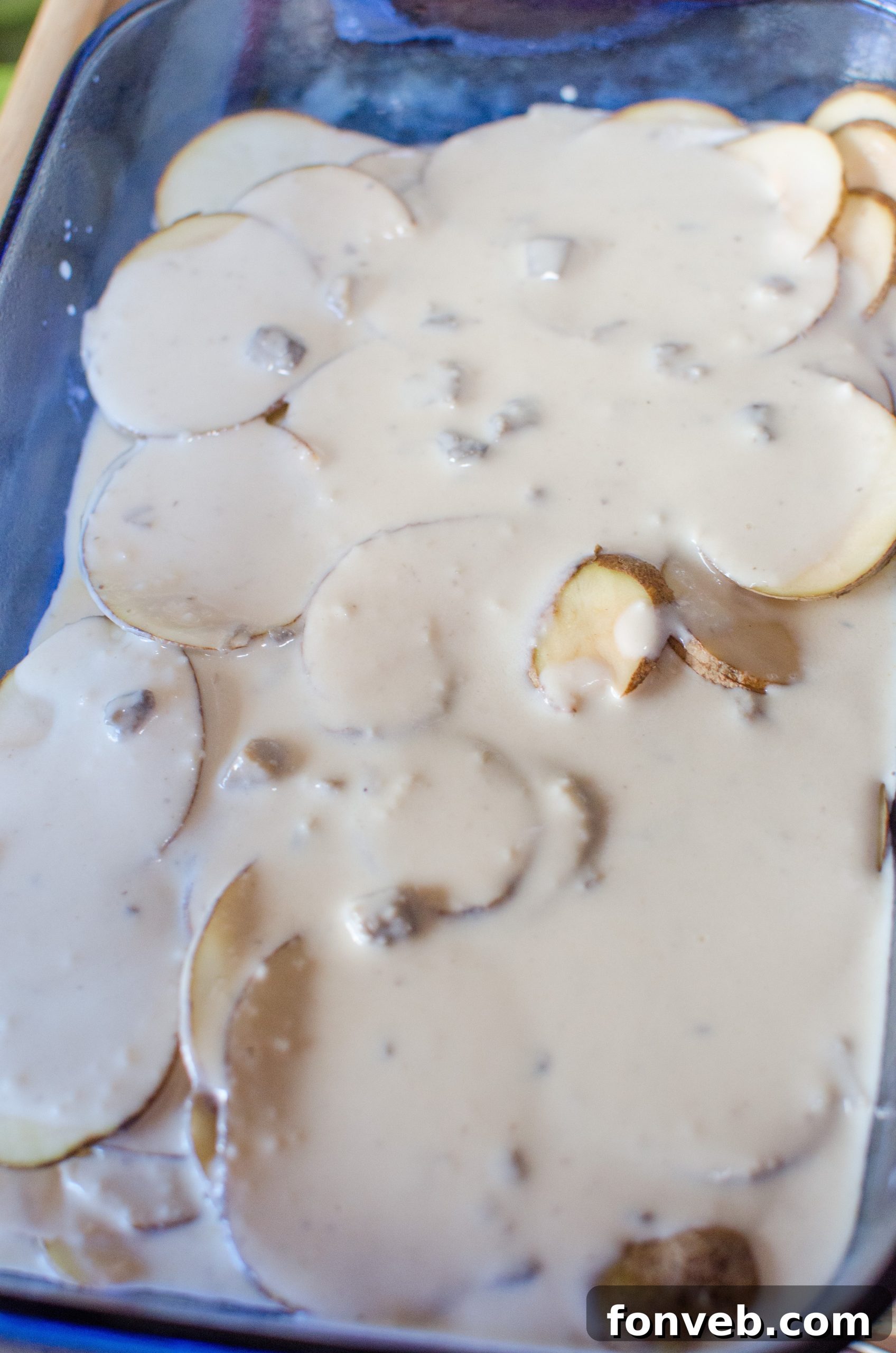 Sliced onions and minced garlic simmering in butter in a hot skillet, releasing their aromatic flavors.