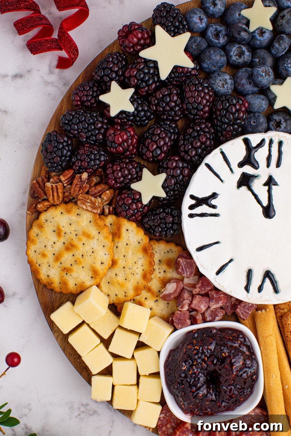 A captivating side view of the New Year's Eve Charcuterie Board, elegantly placed on a table with additional food items casually sprinkled around, enhancing the festive spread.