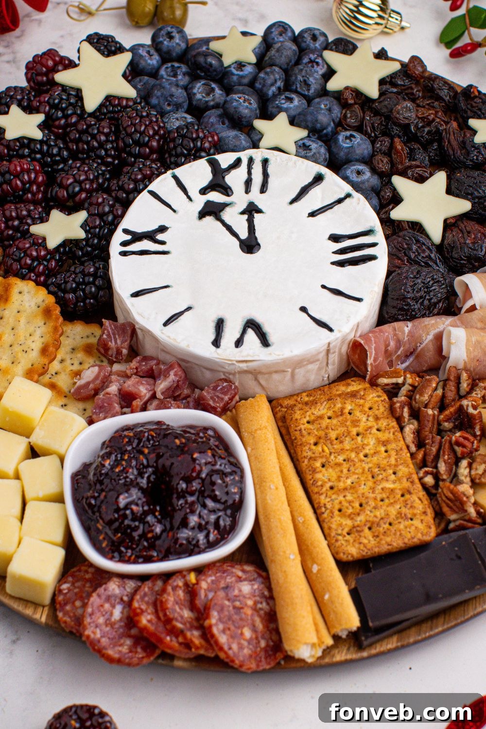 A close-up of the New Year's Eve Charcuterie Board on a table, providing a detailed view of the diverse food selection arranged on the platter.