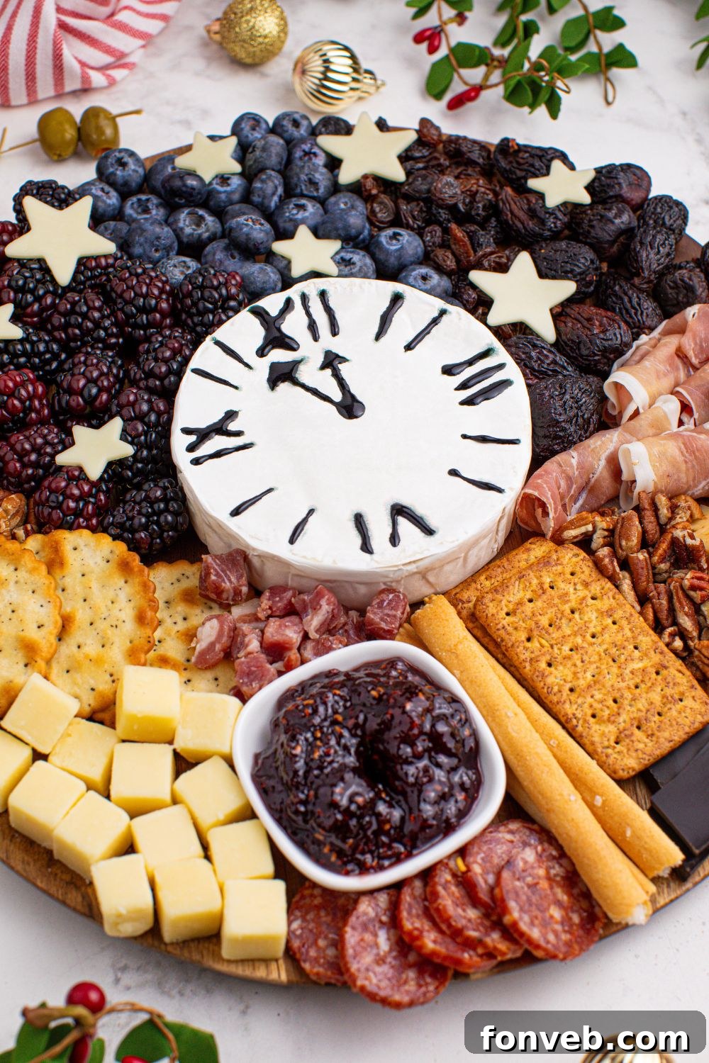 An overhead side view of the New Year's Eve Charcuterie Board, artfully arranged on a marble counter, highlighting the harmonious blend of ingredients.